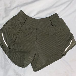 Lululemon green hottie hot shorts with stripes. Size 2  2.5”